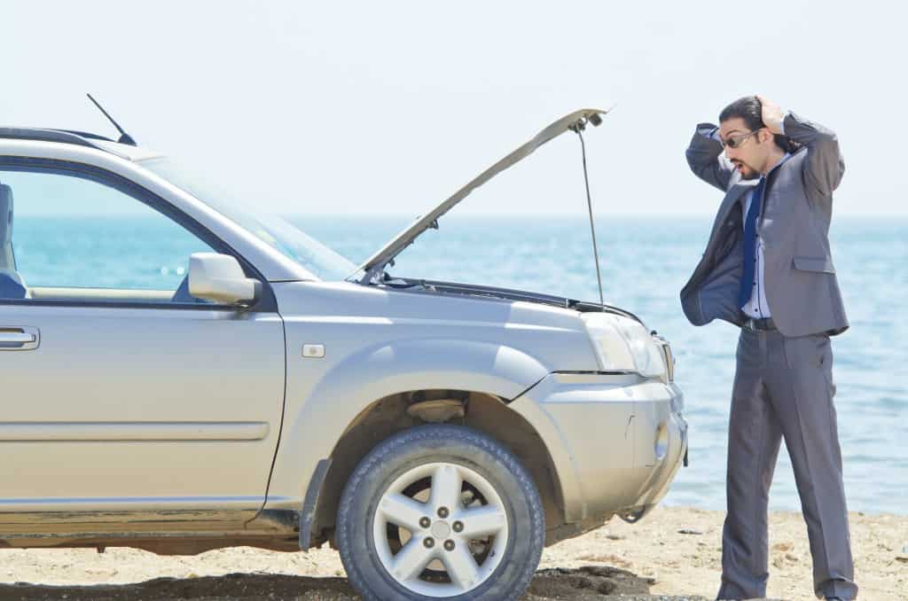 Man with car on seaside